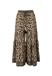 Devï Studios SARL pantalon large noir et beige à motif floral, taille haute, ceinture à cordon avec pompon.