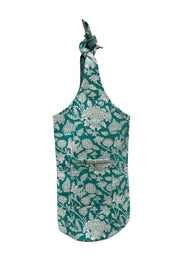 Sac de yoga en coton Devï Studios SARL, imprimé floral bleu sarcelle et blanc, avec poche avant et anse nouée réglable.